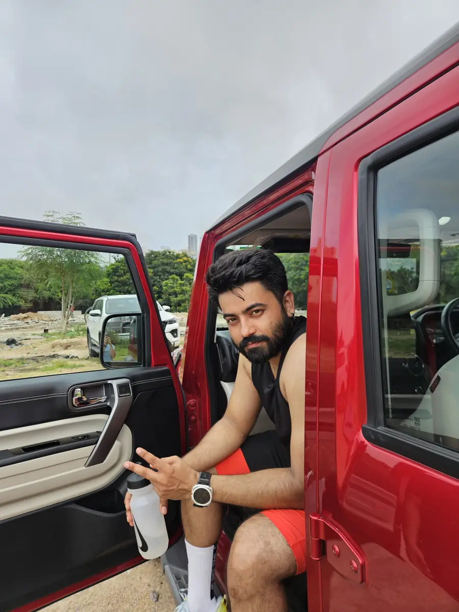 An M³RC runner resting in the doorway of the crew car after a run