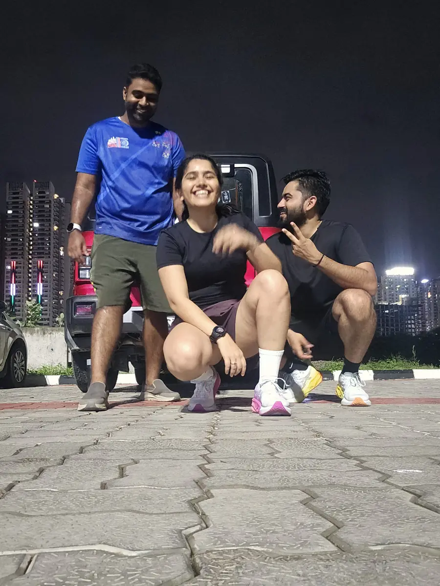 M³RC runners after an evening run, the city lit up behind them